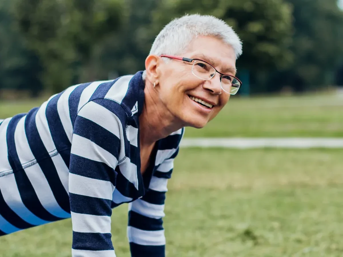 Senior woman doing a strength exercise outdoors