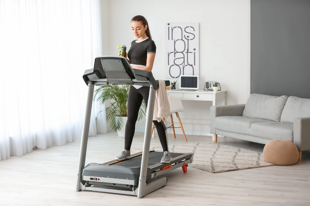woman in walking treadmill at home on a winter
