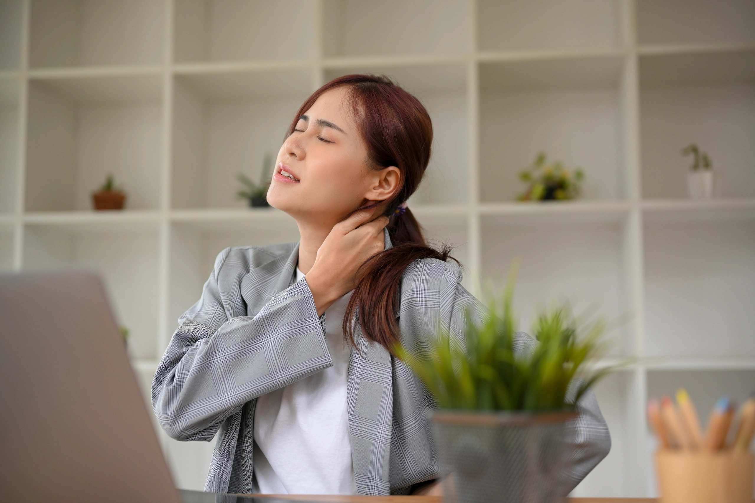 businesswoman tired from work, suffering from neck pain after work